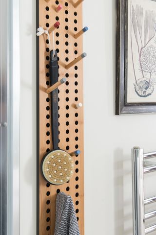 Peg board and hooks with accessories in bathroom