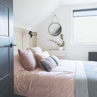A minimalist bedroom with a bed and a widnow