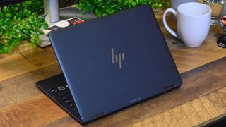 An HP Elite Dragonfly Chromebook on a wooden desk