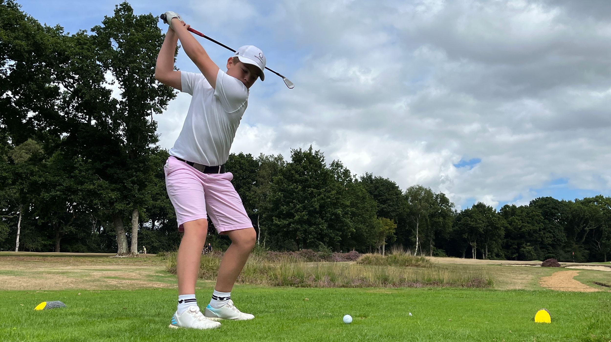 A junior golfer testing a golf glove on the course