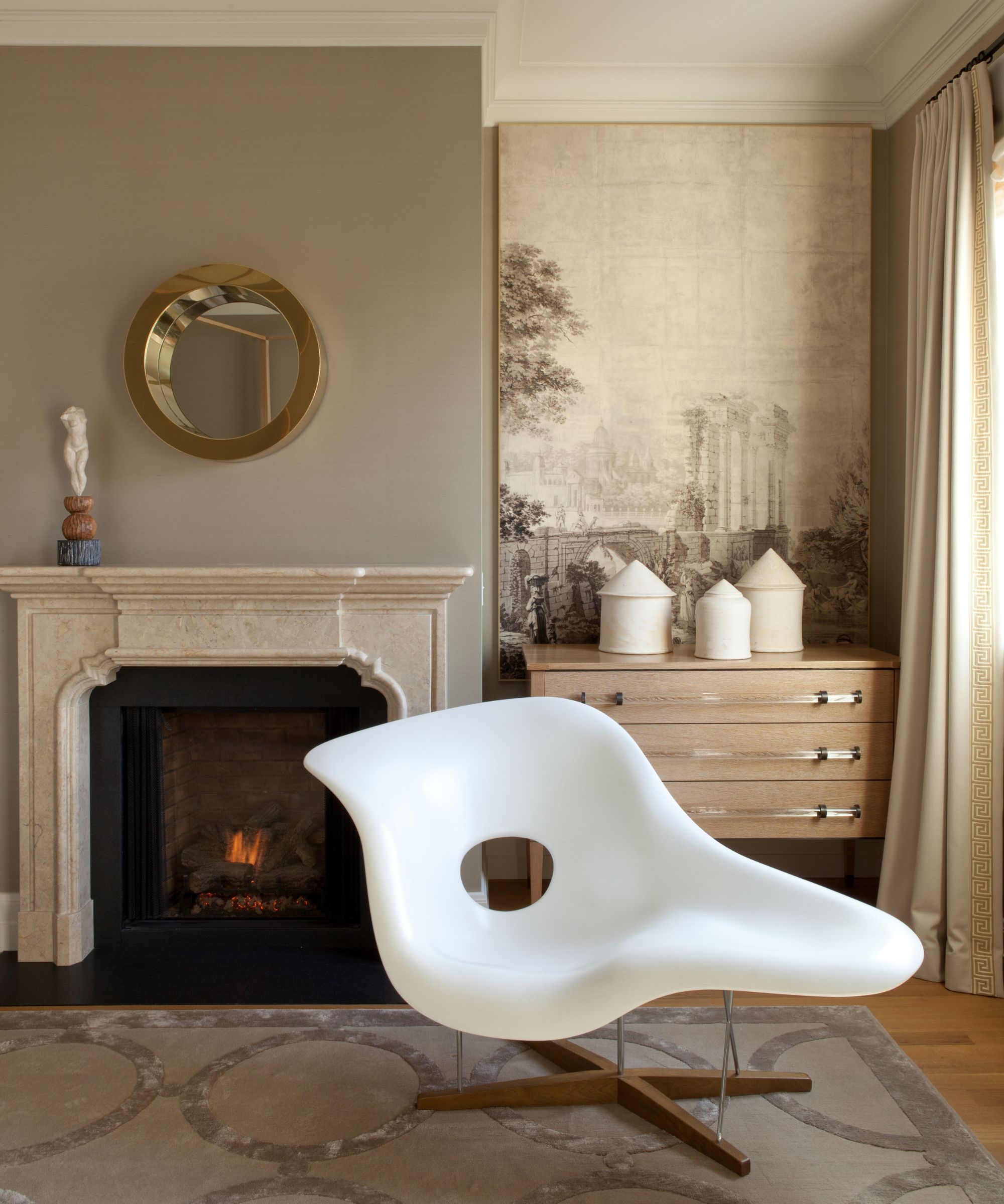 bedroom corner with fireplace and white swivel chair