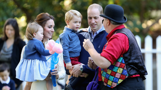 Catherine, Duchess of Cambridge holding Princess Charlotte of Cambridge and Prince George of Cambridge, being held by Prince William, Duke of Cambridge at a children's party for Military families during the Royal Tour of Canada on September 29, 2016 in Victoria, Canada