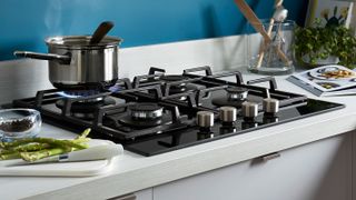 black gas hob with white worktop
