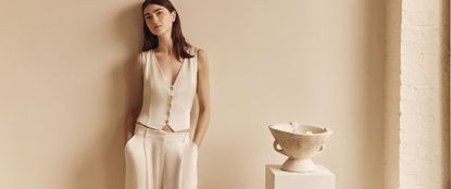 Model wearing neutral outfit sold at Ghost