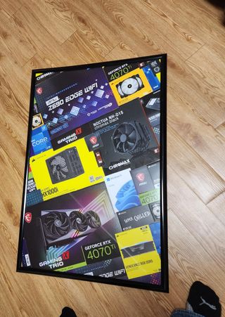 A picture frame with various PC hardware boxes fit within