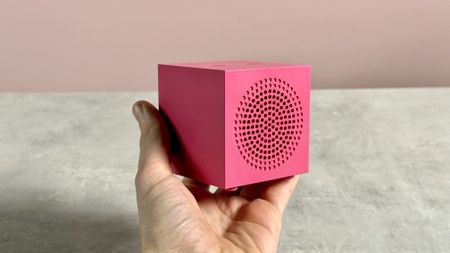 The Ikea Kallsup in Hot Pink help in a man's hand.