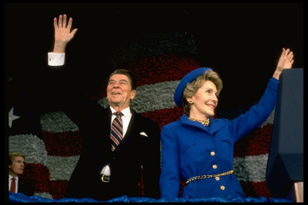 President Ronald Reagan and wife Nancy waving at post-inaugural gathering of marching bands at the Capitol Center. (Photo by Dirck Halstead/Getty Images)