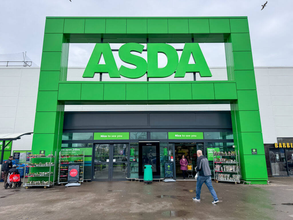 ASDA store front with people entering and exiting the shop
