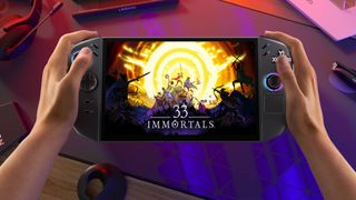Hands holding Lenovo Legion Go 2 handheld with 33 Immortals key art on screen.