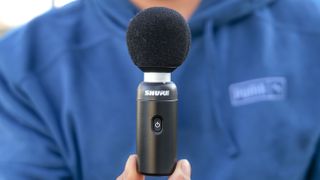 Shure MoveMic 88+ held in the hand.