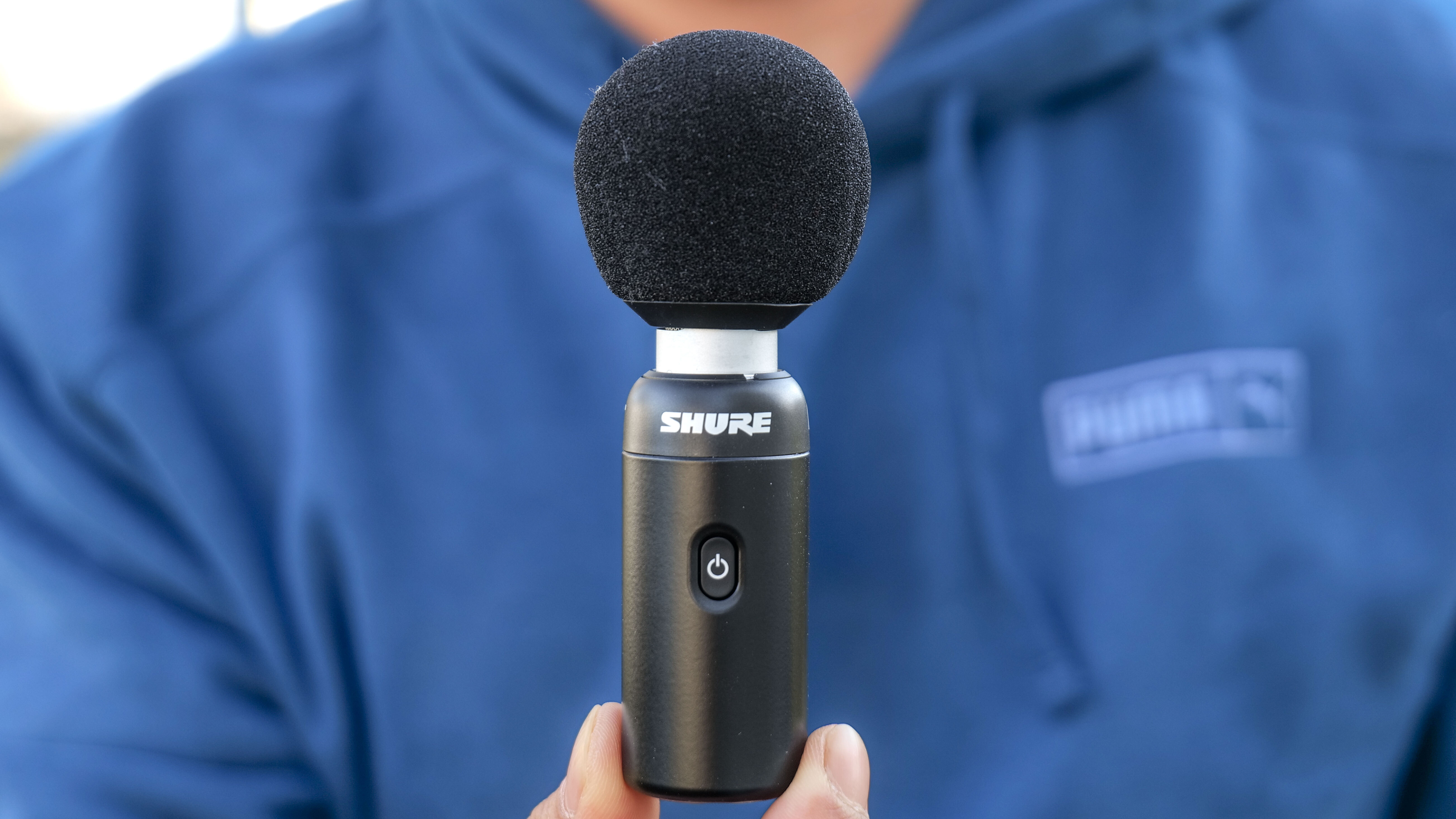 Shure MoveMic 88+ held in the hand.