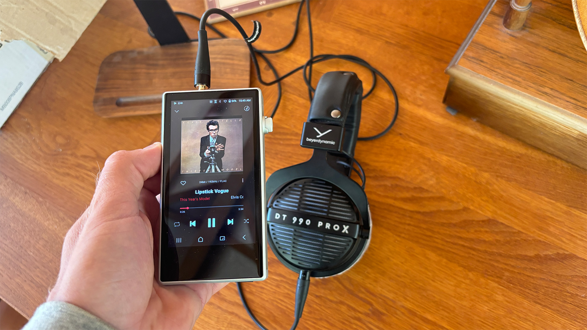 Astell &amp;amp; Kern PD5 portable music player held in hand next to Beyerdynamic headphones