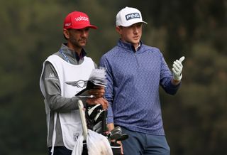 Mackenzie Hughes chats to his caddie during the Genesis Invitational