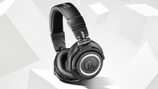 A pair of Audio Technica headphones on a grey and white background