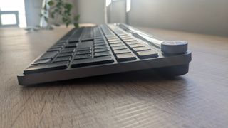 The JLab Epic Wireless Keyboard photographed on a wooden desk.