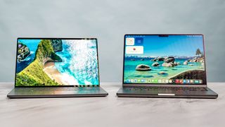Dell XPS 14 vs. MacBook Pro M5 side by side on a table.
