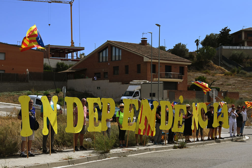 TARRAGONA SPAIN AUGUST 29 Demonstrators protest as they hold up the letters of the word Independencia during the 78th Tour of Spain 2023 Stage 4 a 1846km stage from Andorra la Vella to Tarragona UCIWT on August 29 2023 in Tarragona Spain Photo by Tim de WaeleGetty Images