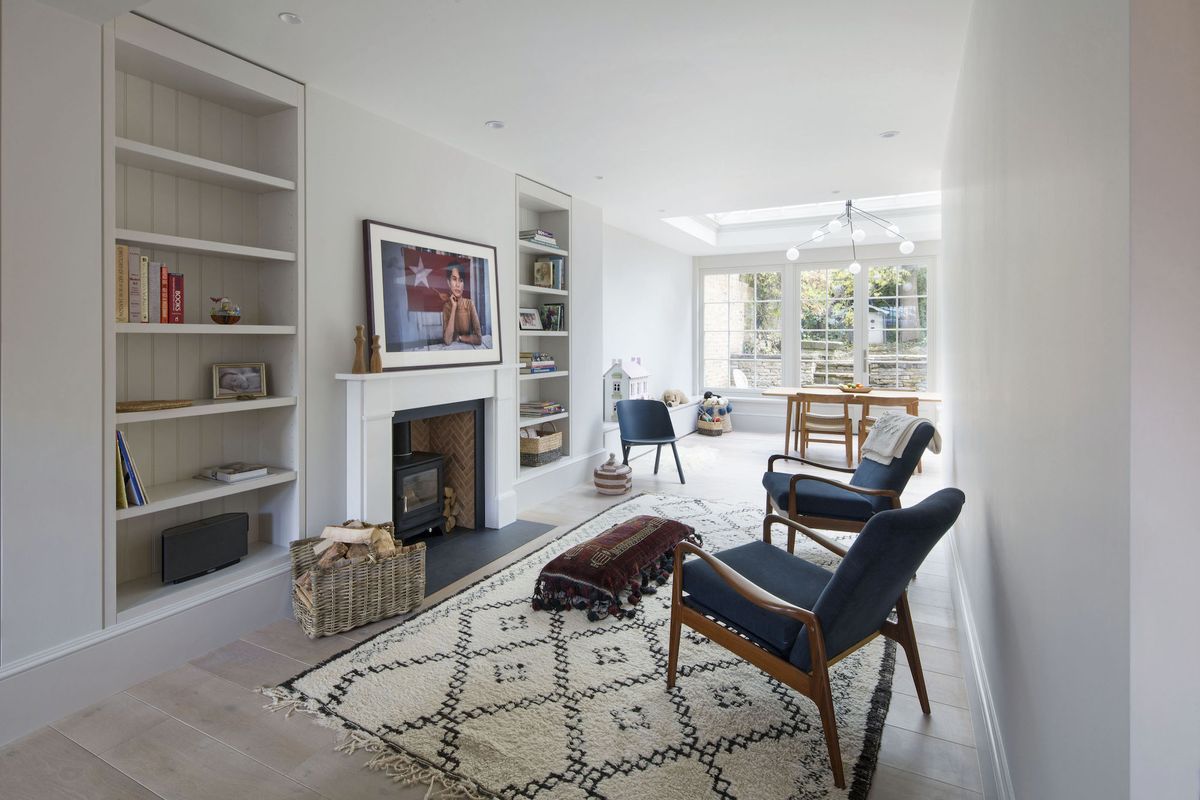 white living room with fireplace and view to conservatory