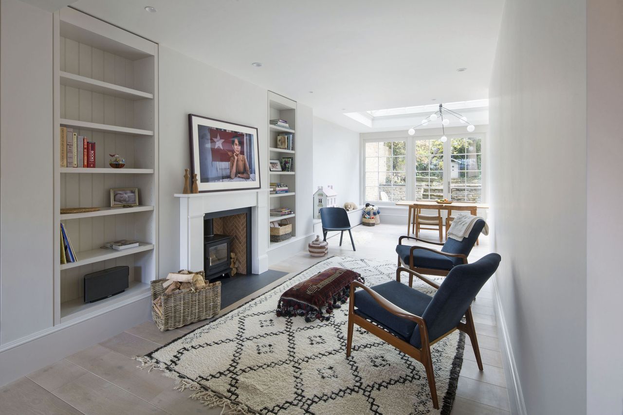 white living room with fireplace and view to conservatory