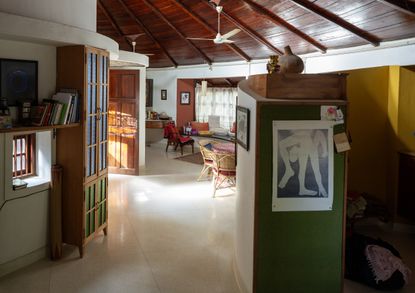 Architect Sandeep Virmani and social activist Sushma Iyengar home interior, circular structure with lots of furniture and art and a timber roof