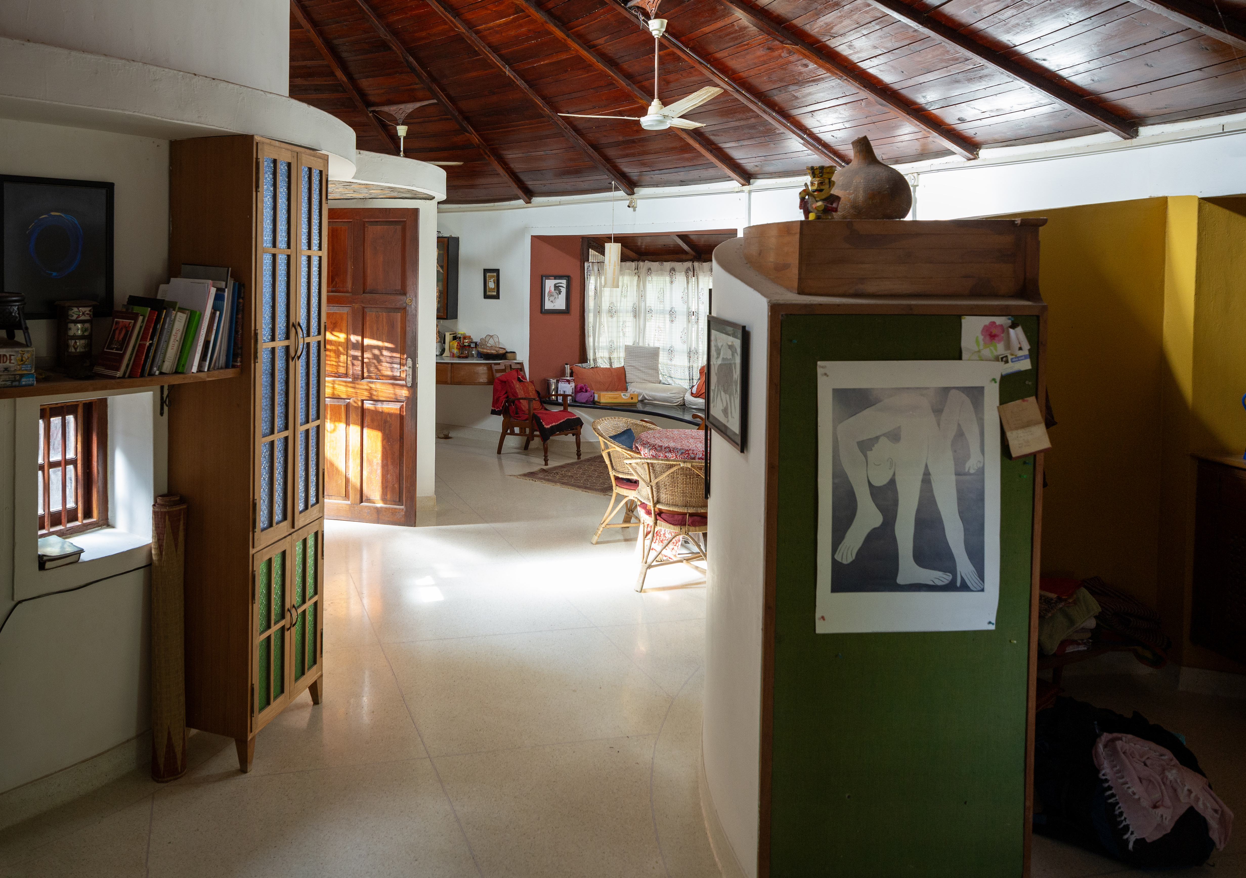 Architect Sandeep Virmani and social activist Sushma Iyengar home interior, circular structure with lots of furniture and art and a timber roof 
