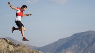 best trail running socks: A trail runner excitedly running down a hillside