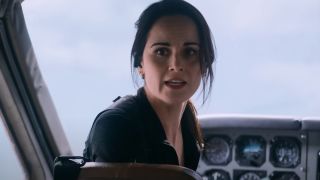 Michelle Dockery looking back from the planes instrument panel with worry in Flight Risk.