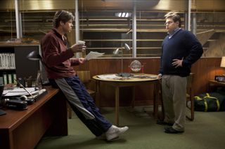 brad pitt and jonah hill talk in an office in the movie moneyball