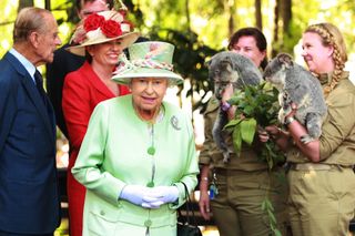 Queensland Premier Anna Bligh shows Queen Elizabeth II a koala.