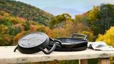 Le Creuset Alpine Outdoor collection set on a wooden table in a mountain setting