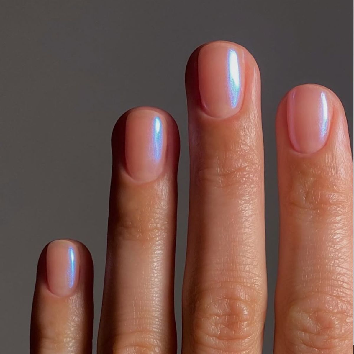 a close-up of blue chrome nails