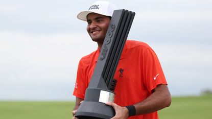Eugenio Lopez-Chacarra poses with the trophy after winning the LIV Golf Invitational Bangkok tournament
