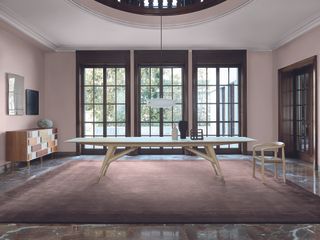 A table by Gio Ponti on pink carpet