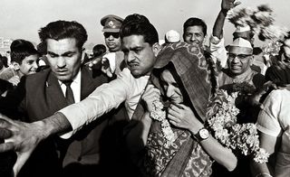 Indira Gandhi being escorted by Security Guards, Delhi’ by Raghu Rai, 1970