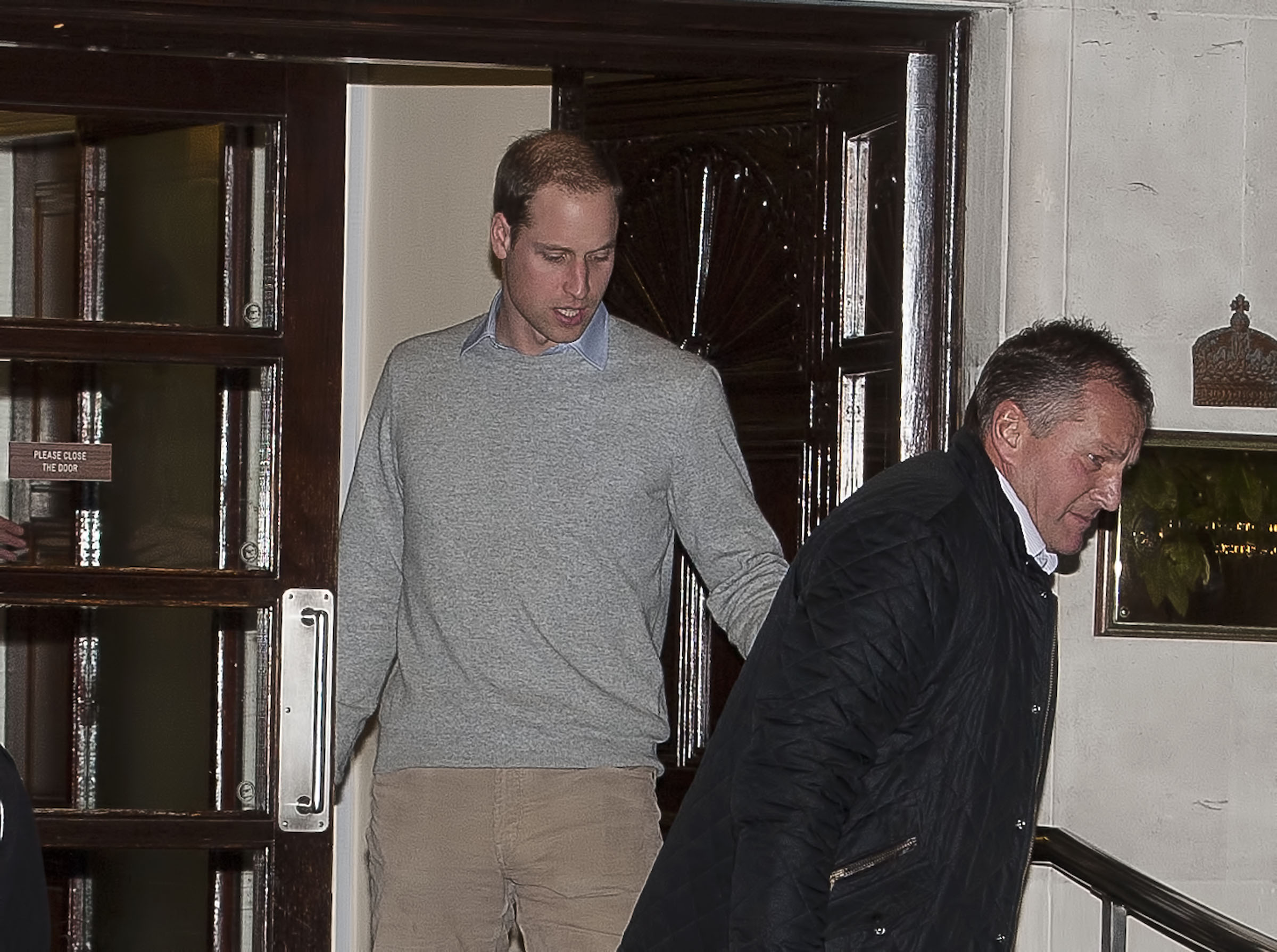 Prince William wearing a gray sweater leaving hospital in December 2012