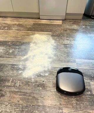 Testing the eufy Pro S1 robot vacuum with a cup of flour on the kitchen floor