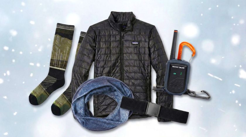 A collection of ski and snowboard accessories including a Patagonia jacket, Rocky Talkie Mountain Radio, Smartwool socks, and a Buff neck gaiter