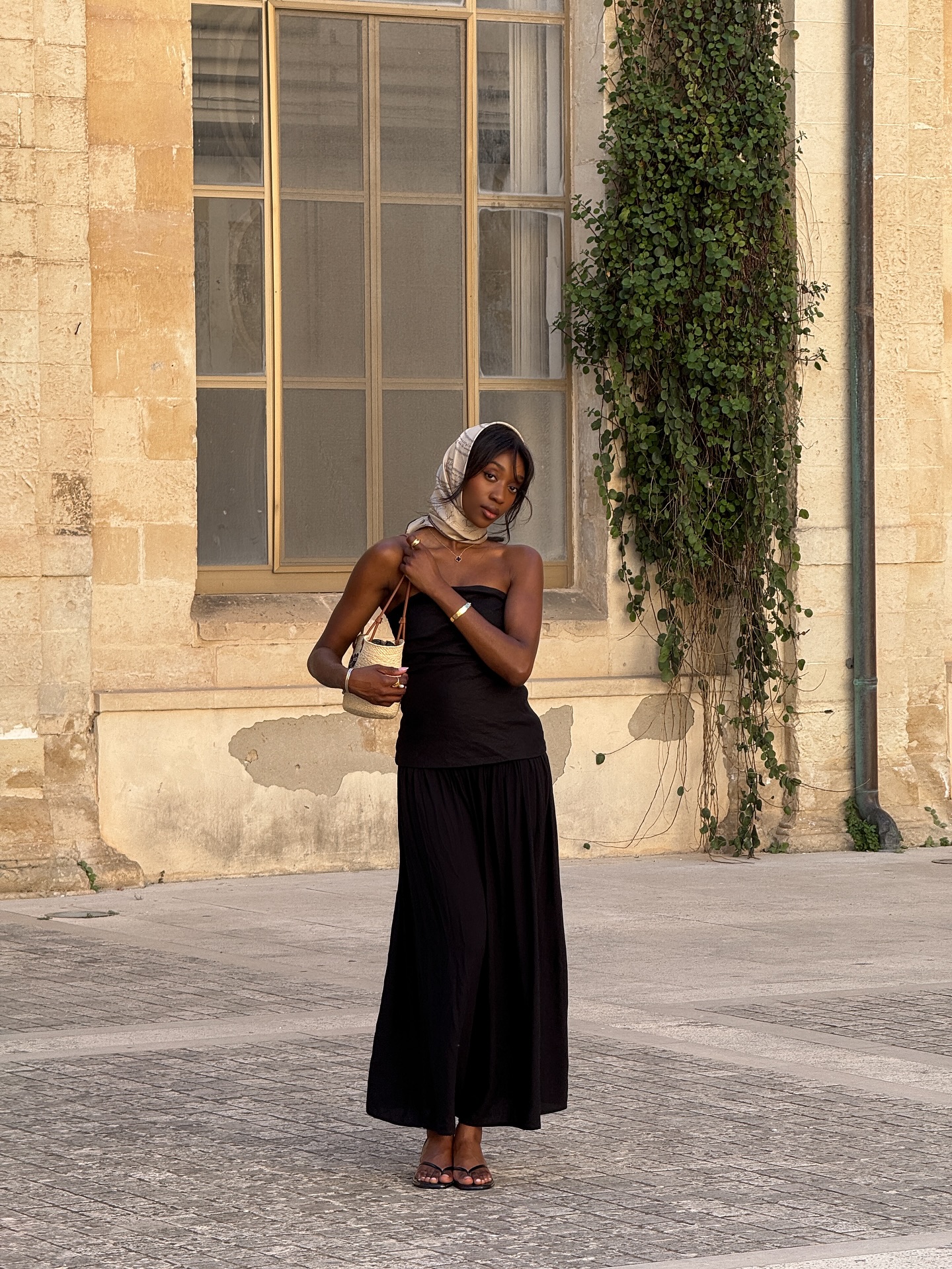Emmanuelle Koffi wearing black maxi dress and headscarf - sunscreens for sensitive skin