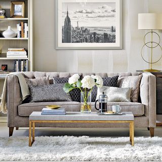 living room with grey sofa set and storage shelves