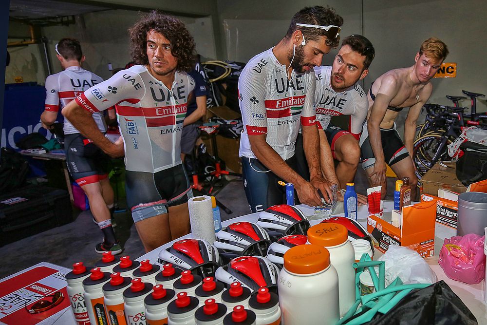 UAE team Emirates riders grab supplies for a training ride in San Juan