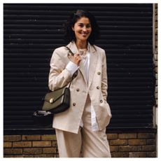 woman wearing a beige linen blazer