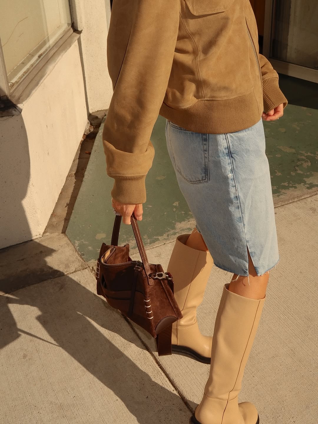 woman wearing bermuda shorts with boots outfit 2025