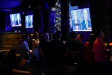 New Yorkers watching the 2024 Presidential Debate between Donald Trump and Joe Biden on TV screens