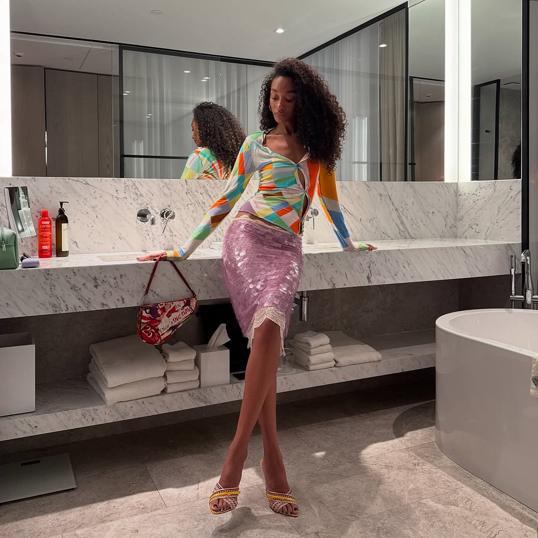 Woman wearing knee-length skirt outfit summer 2025.