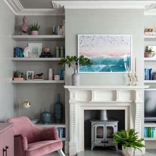 white living room with wall shelves and fire place