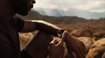Apple Watch Series 7 being used by man on hike