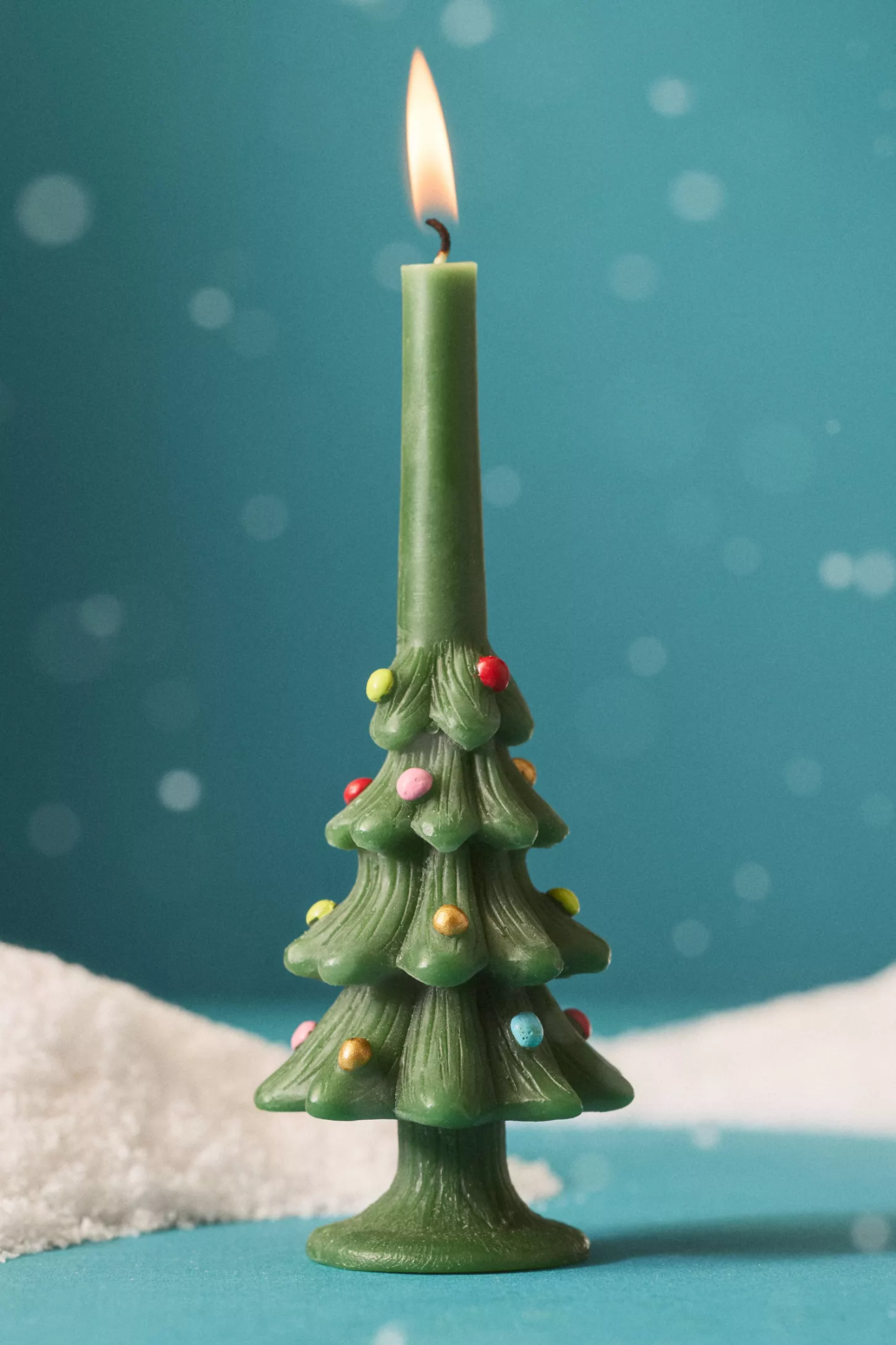 A festive green tree taper candle