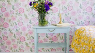 A nesting table beside a bed