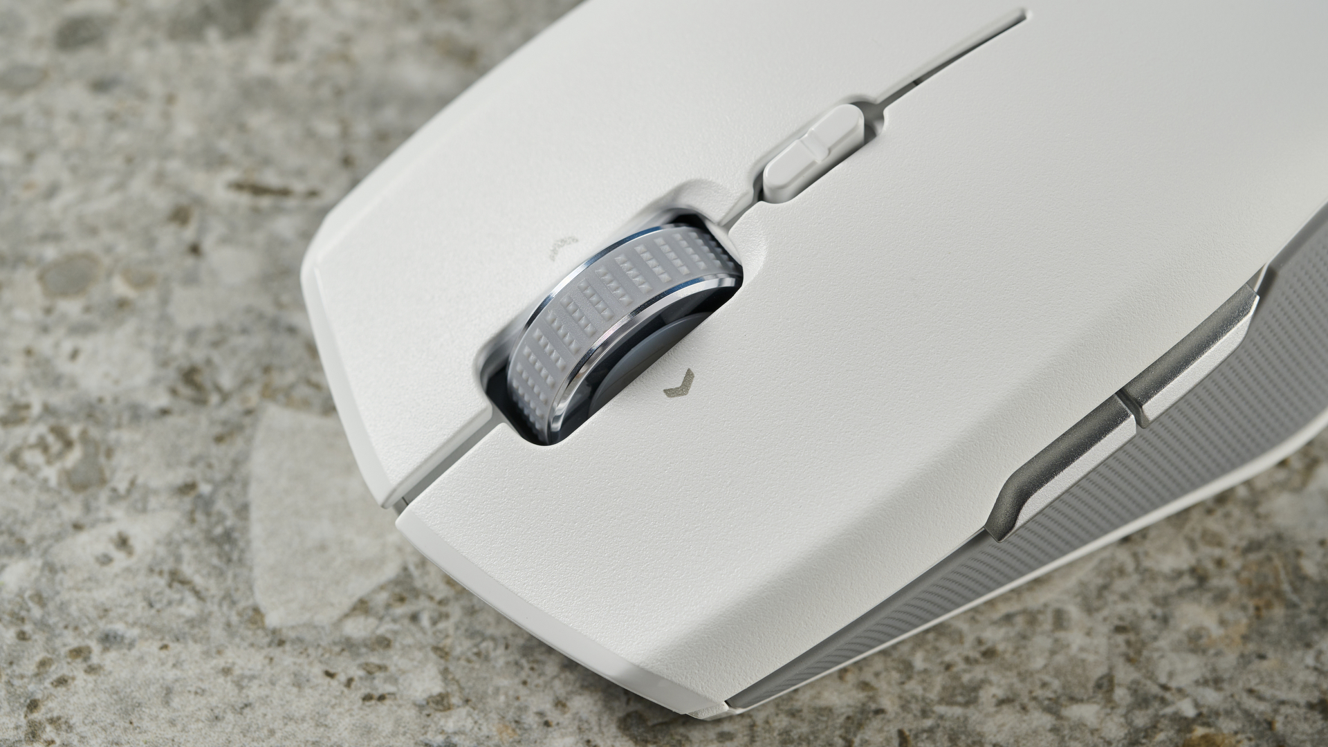 The scroll wheel on a white Razer Pro Click Mini wireless mouse