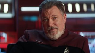 a bearded older man in an official sci-fi uniform